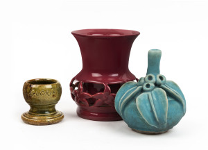 JOHN CAMPBELL pottery egg cup together with a pierced pottery burgundy vase and a gum leaf vase (3 items), the largest 12.5cm high