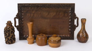 An Indian carved timber tray, huon pine vase and sugar bowl, turned banksia vase, mallee root vase and an Australian specimen wood lidded bowl, 20th century (6 items), 62cm wide