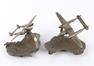 Two WW2 period chrome aeroplane ashtray ornaments with Australian map bases, the bases 16cm wide