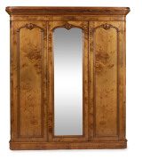 A fine antique Australian three door wardrobe, birdseye huon pine, interior handsomely fitted with slides and drawers, circa 1870, 216cm high, 191cm wide, 57cm deep