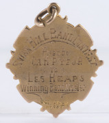 MUSIC AWARDS, ETC: a 9ct gold fob (6.7gms) engraved "Winners Carnival Contest 1922 L.Heaps"; a 9ct gold fob (8.3gms) engraved "Swan Hill 1932" and verso "SWAN HILL BAND CONTEST Pres. by CR. H. PYE, J.P. to LES HEAPS Winning Band Master". Also, a 15ct gold - 8