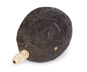 BUGBEAR carved coconut powder flask with whalebone spout and adornments, 18th/19th century, 15cm long