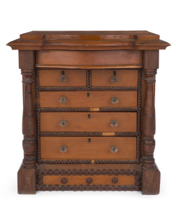 A folk art miniature chest of drawers, stained kauri pine with turned blackwood columns and pressed glass knobs, 19th century, 45cm high, 40cm wide, 26cm deep