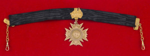 GUNNER Archibald John DUNLOP: 15ct gold fob (approx. 5.5gms; by William Drummond) suspended from a black silk band with a 9ct map of Australia and links. The fob engraved verso "Presented to Gunner A.J. Dunlop on his return from the Great War : Stewarton 