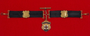 Brother G.W. LORRIMAN: 9ct gold fob suspended from a black silk band with 9ct shields and links. The fob, with Manchester Unity I.O.O.F. shield to front, engraved verso "Loyal Woods Point Lodge M.U. - Presented to Bro. G.W. LORRIMAN. Appreciation for Serv