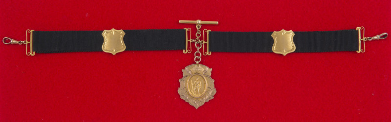 9ct gold fob suspended from a black silk band with 9ct shields and links. The fob, with a soldier and a map of Australia to front, engraved verso "Portland Rifle Club War Service Medal Presented to S.H. Haynes 1920". Samuel Henry HAYNES of Cashmore, Vict