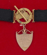 9ct gold fob suspended from a black silk band together with 9ct map of Australia, shields and links (apprx. 10gms total). The fob, engraved verso "Presented to Gnr. P.A. Wylde by Spalding Residents For Services Rendered for King & Country, from March 1915 - 2