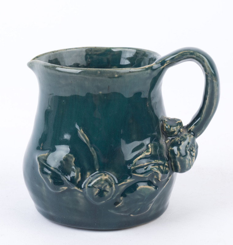 DUNHAM (R.M.I.T. SCHOOL, Melbourne) green glazed pottery jug with applied fruit and branch handle, incised "M. Dunham", 11cm high, 12cm wide