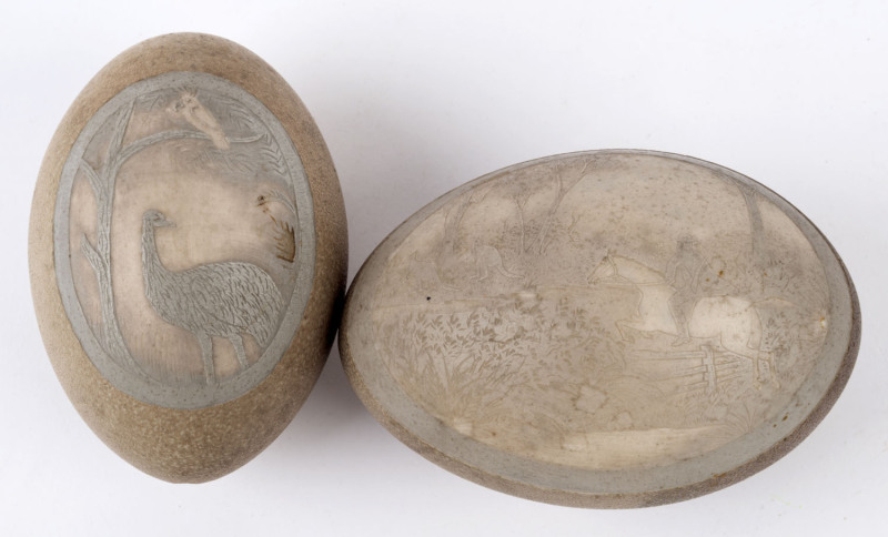 Two antique emu eggs with carved vignettes, late 19th century, the larger 13cm high