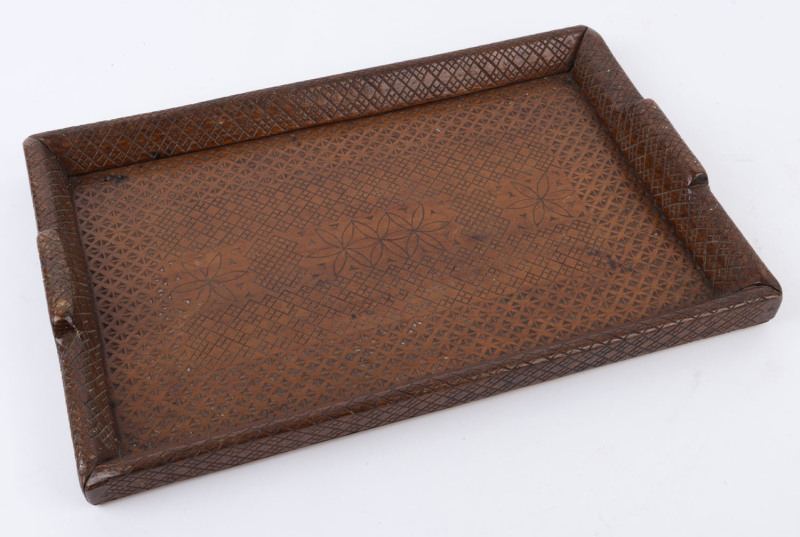 An Australian serving tray with chip carved geometric decoration, early 20th century, ​46cm across the handles