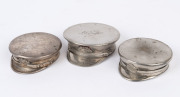 Three nickel plated powder compacts in the form of military caps, one engraved "My Duntroon Souvenir, 1951", ​the largest 8cm wide