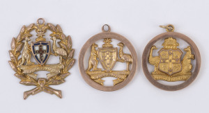 Three different 9ct gold fobs (5.8gms), each incorporating an Australian coat-of-arms; one with the Australian military rising sun above the shield. (3).