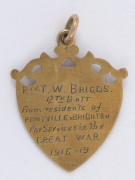 9ct gold fob (4.7gms) presented to Private Thomas William BRIGGS, 12th Battalion, by the residents of PONTVILLE BRIGHTON for his "Services in the GREAT WAR"; map of Tasmania on the front and engraved verso. - 2