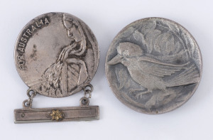 A Mothers and Widows Badge, by Amor, Sydney; being a round white metal badge bearing the image of a grieving woman with a laurel wreath and the words 'FOR AUSTRALIA'. A bar is attached to the bottom of the badge bearing a brass star to represent one child