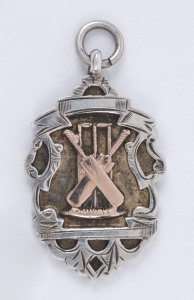 A silver & 9ct gold cricket award fob engraved verso "NEWS LEAGUE - 1930 - WINNER G. COX".