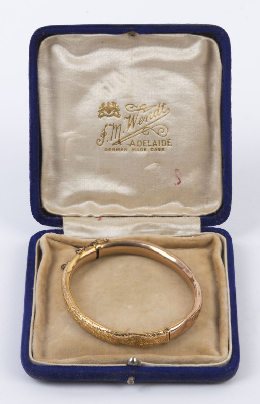 A lady's antique 9ct gold bangle with engraved decoration, late 19th century, 7cm wide, 6.6 grams total. Housed in plush velvet box branded "J.M. WENDT, ADELAIDE",