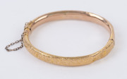 A lady's antique 9ct gold bangle with engraved decoration, late 19th century, 7cm wide, 6.6 grams total. Housed in plush velvet box branded "J.M. WENDT, ADELAIDE", - 2