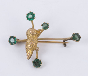 An antique Australian 9ct yellow gold kookaburra and Southern Cross brooch set with green stones, Melbourne, circa 1900, stamped "9" with pictorial marks, ​4cm wide, 2.5 grams total