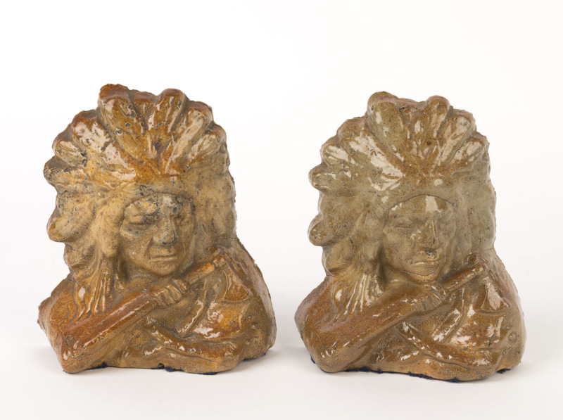 A pair of brickworks workman's pottery bookends in the form of Native American Indians, 18cm high