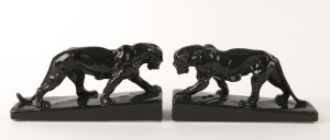 A pair of charcoal glaze pottery panther bookends, ​12.5cm high, 24cm wide