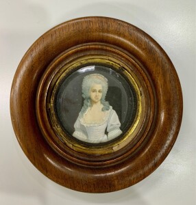 ADAM, (French School), Miniature portrait of a lady, watercolours and white highlights, signed and dated "Adam 1743" at lower left, 7cm diameter.