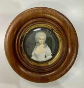 ADAM, (French School), Miniature portrait of a lady, watercolours and white highlights, signed and dated "Adam 1743" at lower left, 7cm diameter.