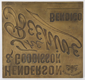 HENDERSON & GOODISSON : THE BEEHIVE STORES, BENDIGO: Brass printing plate, circa 1900, for the well-known Bendigo store; made by the Morris Manufacturing Co, Box Makers, Melbourne. The plate bears the "By Special Appointment Coat-of-Arms" by which Henderson & Goodisson made it known that they had Vice-Regal recognition. 30.5 x 30.5cm.