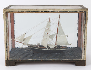 A folk art model ship in cabinet, 19th century, 28cm high, 40cm wide, 19cm deep