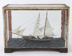 A folk art model ship in cabinet, 19th century, ​28cm high, 40cm wide, 19cm deep