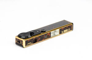 NIKKOH (Japan): Enica-SX, c1983, sub-miniature camera for 8x11mm exposures on Minox cassette film (one unexposed cassette present); tortoise-shell covering; gold edges; Suzunon f3.8 14.3mm lens. With original chain, case, packaging and instructions.