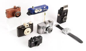 P: A diverse group including a PENTAX Auto 100 Super, a PHOTO-MASTER in orange-marbled finish and another aluminium PHOTO MASTER Super 16 TWIN 620, a PICKWIK reflex-style bakelite camera by Monarch, a POLAROID I-Zone, a POLICE Watch Camera by Ulead in ori