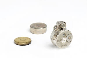 PETAL KOGAKU CO. (Japan): Petal, round-body sub-miniature camera, c1948, with film magazine and film can containing unexposed film discs. The camera & the darkroom loading can marked "Made in Occupied Japan". (3 items).