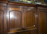 A fine Colonial Beaconsfield gentleman's wardrobe with inverted breakfront, Australian cedar with huon pine secondary timbers and blackwood knobs, Tasmanian origin, circa 1850. Bearing label on the back "A. JONES, LAUNCESTON". 203cm high, 220cm wide, 70cm - 5