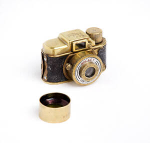 ROCKET CAMERA CO. (Japan): New Rocket, c1946-49, sub-miniature camera in gold metal, with "NEW Rocket" on top; Rocket f4.5 20mm lens plus Rocket Model No.2 filter.