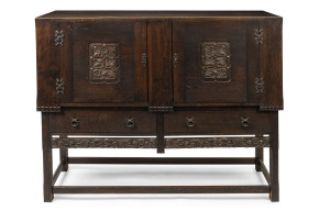 An Arts and Crafts sideboard, carved oak with Japanned finish, early 20th century, beautifully crafted with external dovetail construction, 117cm high, 153cm wide, 51cm deep