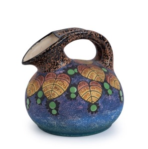 An Amphora Art Deco porcelain jug decorated with leaves and enamel berries, circa 1925, oval factory mark "Amphora, Made In Czechoslovakia", 16cm high, 16cm wide