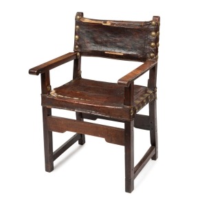 An antique Spanish armchair, walnut with leather upholstery and large brass studding, 17th century, 65cm across the arms