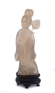 An antique Chinese carved mutton jade statue of a lady holding a flower, Qing Dynasty 18th/19th century. 14cm high