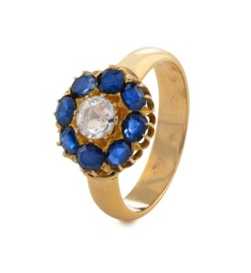 An impressive 9ct yellow gold ring set with central diamond surrounded by blue sapphires, stamped "375"