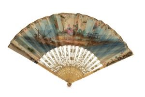 A HAND-PAINTED FAN: circa 1800, depicting nobility in a French garden, painted in gouache on eighteenth century paper, 47 x 27cm, openwork ivory frame and decorated with silver and gold metal applications of cherubs and flowers; the reverse with a scene o