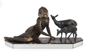 A French vintage Art Deco statue of a lady feeding deer, cast metal remains of silver finish on marble and mirrored base, circa 1935, 28cm high, 57cm wide.