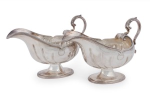 A pair of English sterling silver gravy boats with shell decoration, made by Atkin Brothers of Sheffield, circa 1930, 14cm high, 18cm wide, 726 grams total
