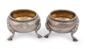 A pair of sterling silver salt cellars with engraved decoration, London, circa 1869, 4cm high, 6cm diameter, 126 grams total