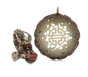 A Chinese pendant, carved mutton jade set in silver with enamel decoration; together with a Chinese silver and coral dragon ring, ​19th/20th century, (2 items), the pendant 5cm high