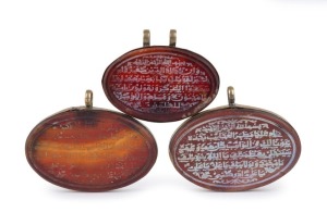 Three antique Ottoman agate pendants carved with passages of the Quran, 18th/19th century. See "THE ART OF SMALL THINGS". AUTHOR: JOHN MACK. THE BRITISH MUSEUM PRESS. 2007. ISBN 978.0.7141.5046.8. PAGE 169. the largest 5.5cm wide