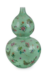 A Chinese Hu-lu Ping vase (double gourd shaped) with enamel floral and butterfly decoration on jade green ground, Republic period, underglaze blue Qianlong mark, 32.5cm high