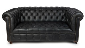 A black leather Chesterfield style two seat settee, late 20th century, ​​​​​​​180cm across the arms