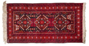 A small Persian hand-knotted rug with geometric design ​​​​​​​116 x 55cm
