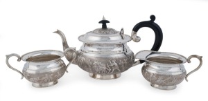 An antique Indian silver three piece tea service with elephants and farming scenes, 19th century, stamped "SILVER", ​​​​​​​the teapot 17cm high, 30cm wide, 1,364 grams total