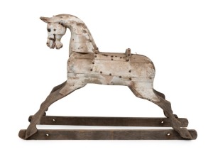 An antique rocking horse, carved wood with remains of white painted finish, 19th century, ​​​​​​​78cm high, 114cm long